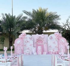 a pink and white wedding set up outside