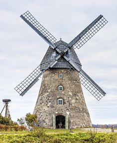 an old windmill in the middle of a field