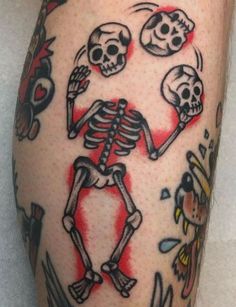 a person with a tattoo on his leg that has skulls and bones all over it