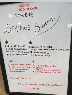 a white sign with writing on it in front of a brick wall that says towers springs summit