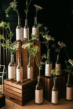 several bottles with flowers in them sitting on a table