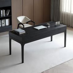 a black table with a white chair and bookshelf in the backround