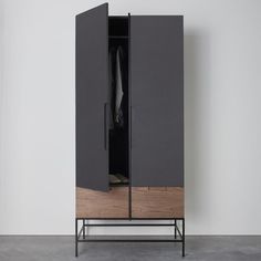 an armoire with a coat hanging on it