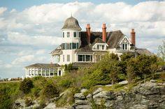 a large white house sitting on top of a cliff