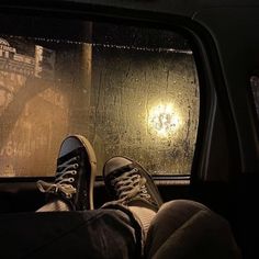 someone is sitting in the passenger seat of a car with their feet on the dashboard