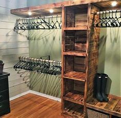 a wooden shelf filled with shoes next to a wall mounted coat rack and shoe rack