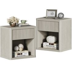 two small side tables with books and vases on each shelf, one is gray