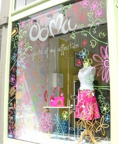 a window display with pink and green flowers on it