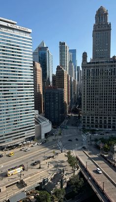 an aerial view of a city with skyscrapers in the background and cars driving on the road