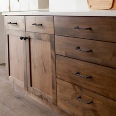 a kitchen with wooden cabinets and white counter tops