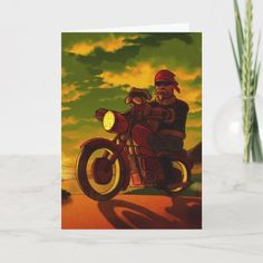 a greeting card with an image of a man riding a motorcycle on the road at sunset