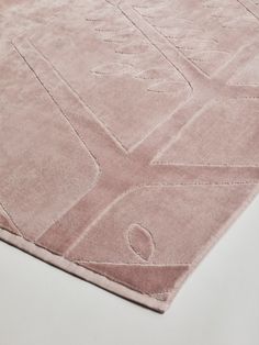 a pink rug on top of a white table