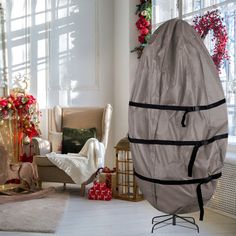 a living room decorated for christmas with decorations and presents on the floor, including a chair