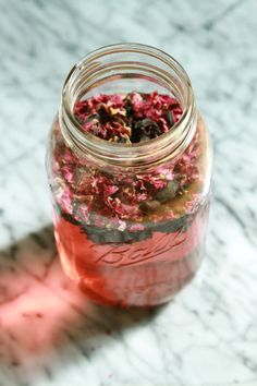 a jar filled with lots of pink flowers