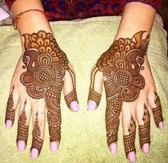 two hands with henna tattoos on them