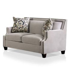 a gray couch with two pillows on it's back and one arm facing the camera