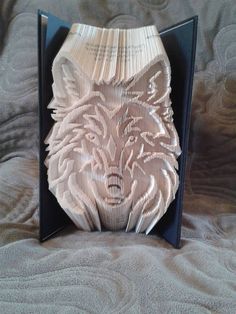 a white wolf head carved into the side of a black frame