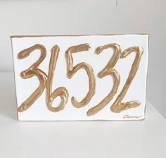 a white and gold birthday card with the number 3502 on it's side