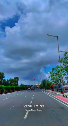 an empty street under a cloudy sky with the words vesu point written on it