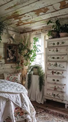 a bedroom with white furniture and plants on the wall