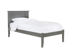 a gray bed frame with white sheets and pillows