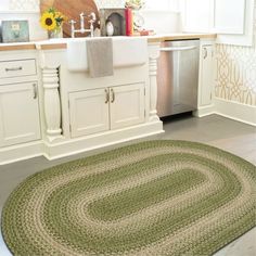 a kitchen area with sink, dishwasher and rug