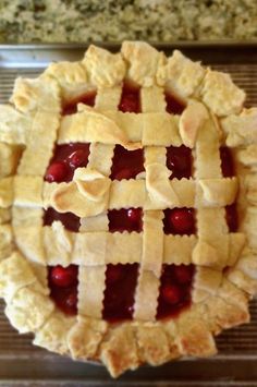 a pie with latticed crust and cherries on top