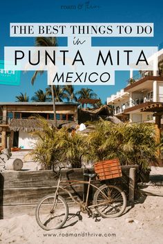 a bike parked in front of a building with palm trees and the words, the best things to do in punta mita mexico