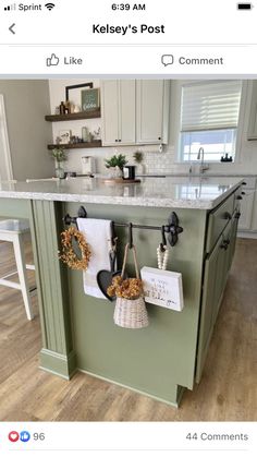 a kitchen island with two pots and pans hanging from it's hooks on the wall