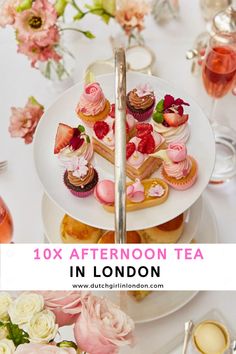 an afternoon tea party in london with pink flowers and cupcakes on the table