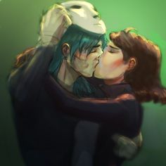 two people are kissing each other in front of a green background