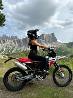 a woman sitting on top of a dirt bike