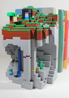 a lego model of a house made out of legos and books on a white background