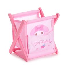 a pink toy chair with a hello kitty design on the front and side pocket for storage