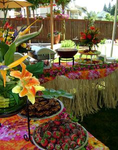 a table topped with lots of different types of food and flowers on top of it