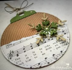 a piece of paper with musical notes on it and a green plant in the middle