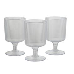 three clear glass goblets sitting next to each other