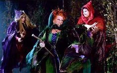 three women dressed as witches in the woods