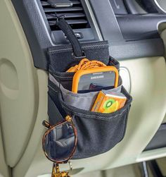 the inside of a car pocket holds cell phones, sunglasses and other gadgets