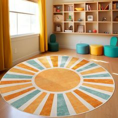 an orange and blue rug in the middle of a living room with bookshelves