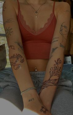 a woman with tattoos on her arms and legs