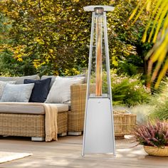 a patio heater sitting on top of a wooden deck next to a couch and potted plant