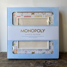 two pieces of paper with the words monopoly printed on them are sitting in a box