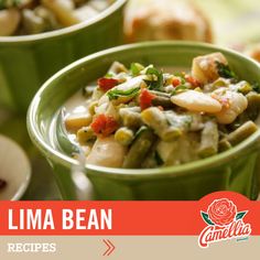 two green bowls filled with food sitting on top of a table next to another bowl