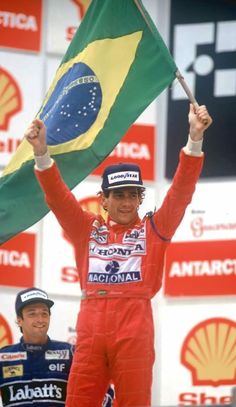 a man holding up a flag on top of a podium