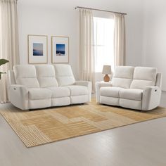 a living room with two white couches and a rug