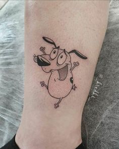 a small cartoon character tattoo on the leg and foot, which is drawn in black ink