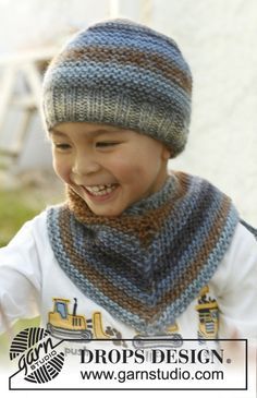 a young boy wearing a knitted hat and scarf