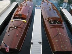 two wooden boats are docked in the water