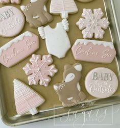 baby shower cookies decorated with pink and white icing on a cookie sheet in a baking tin